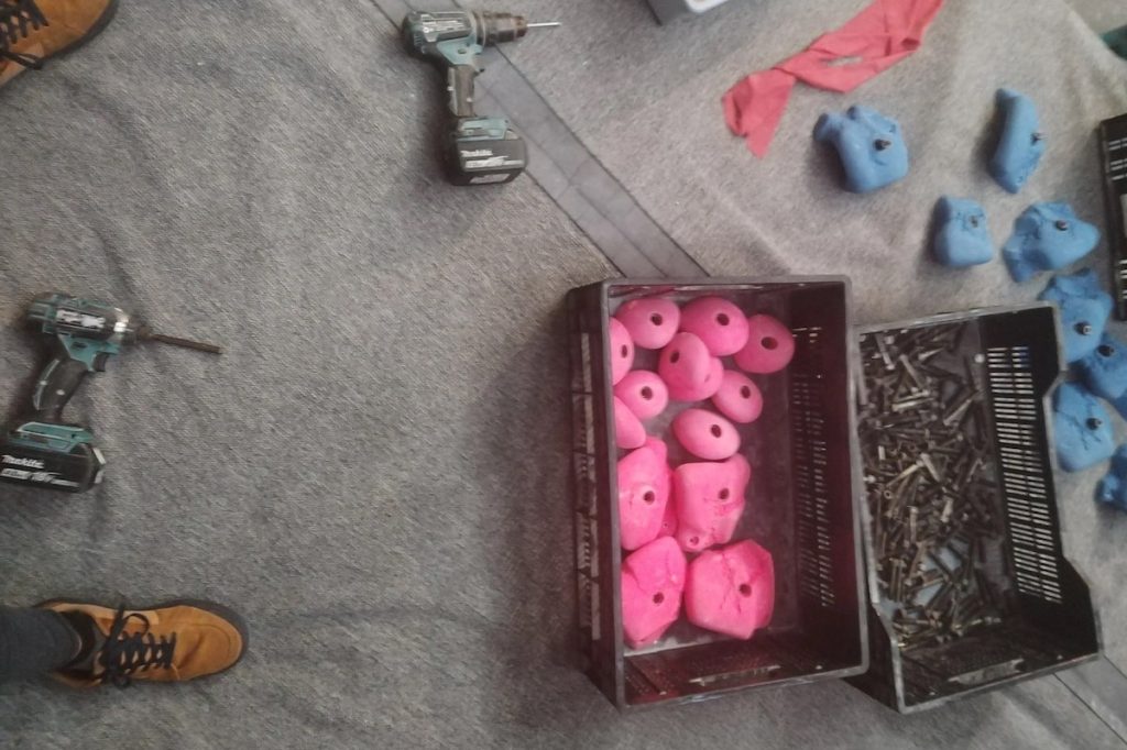 Joffs feet, electric drills, and climbing holds at Bloc 11